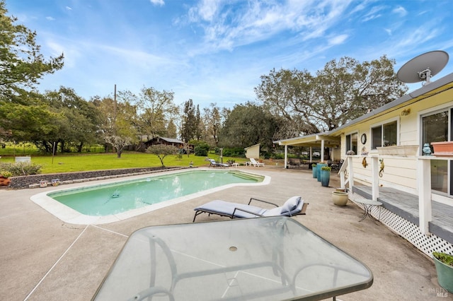 pool featuring a yard and a patio