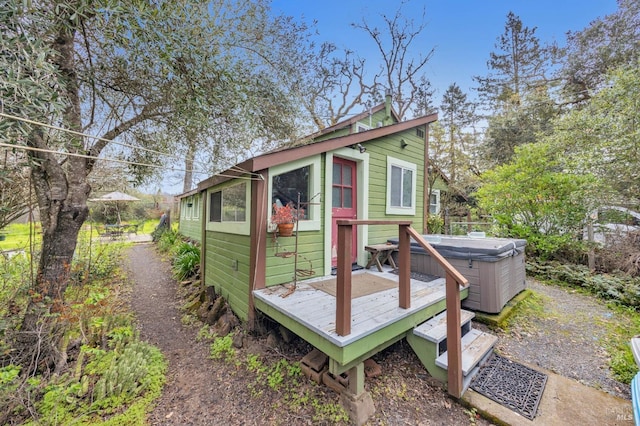 view of outbuilding featuring a hot tub