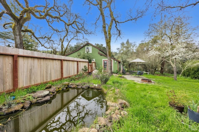 view of yard featuring fence and a patio area