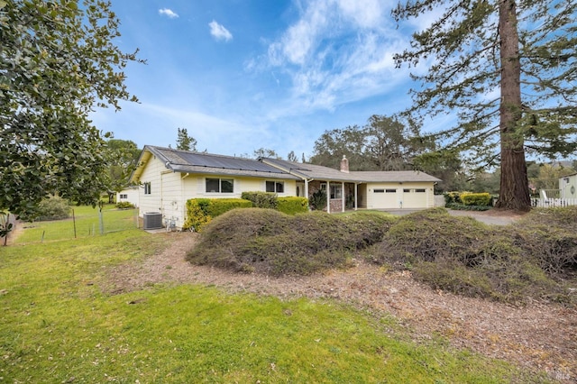 single story home with a front yard, a chimney, fence, central AC unit, and a garage