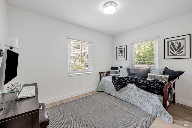 bedroom with baseboards and light wood-style flooring
