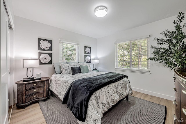 bedroom featuring baseboards and light wood-type flooring