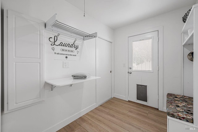 mudroom with light wood-style floors