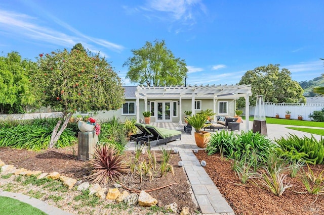 back of property with french doors, stucco siding, fence, a pergola, and a patio