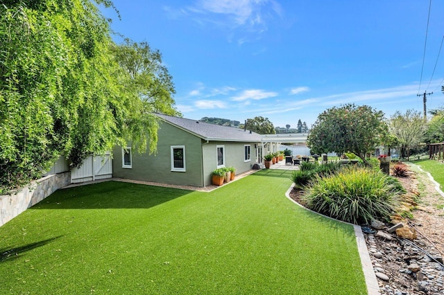 view of yard with a fenced backyard and a patio