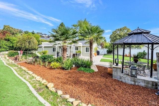 view of yard with a gazebo, fence, and a patio area
