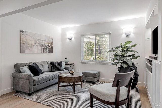 living area featuring light wood-style flooring and baseboards