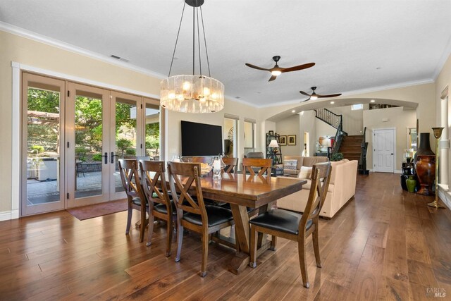 dining space with french doors, dark wood finished floors, visible vents, stairs, and crown molding