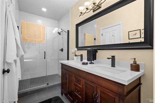 full bath with a sink, a stall shower, double vanity, tile patterned flooring, and recessed lighting