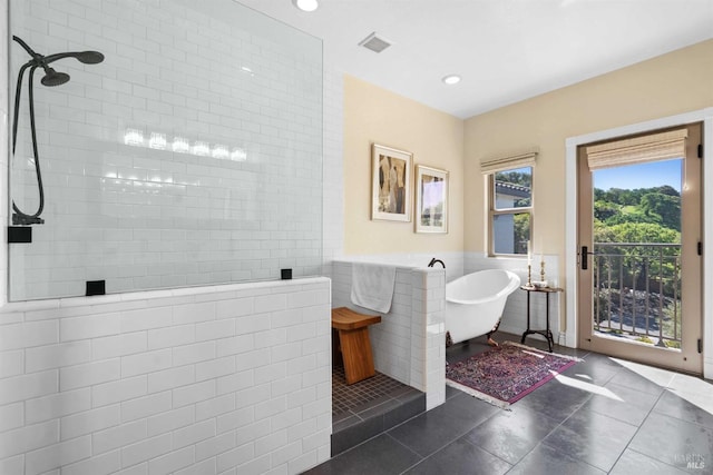 bathroom featuring a soaking tub, tile walls, visible vents, walk in shower, and tile patterned flooring
