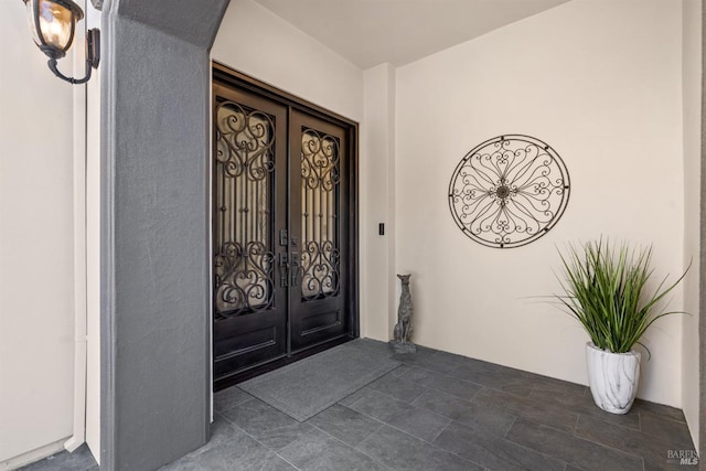 doorway to property with french doors and stucco siding