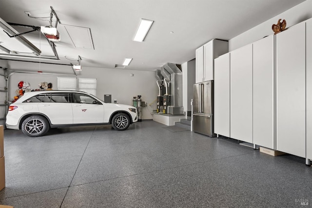 garage featuring heating unit, a garage door opener, and high end refrigerator