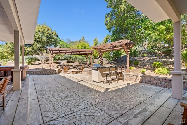 view of patio with a pergola, outdoor dry bar, and an outdoor kitchen