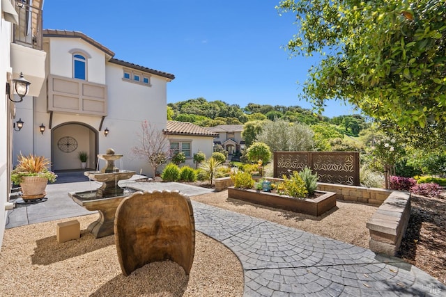exterior space with stucco siding and a tile roof