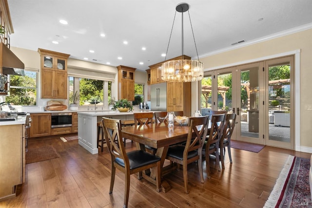 dining area featuring recessed lighting, french doors, crown molding, a chandelier, and dark wood-style flooring