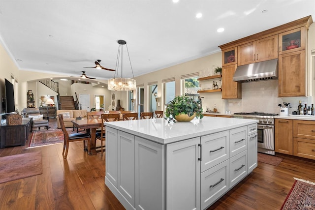 kitchen featuring high end stainless steel range, a center island, ceiling fan, light countertops, and under cabinet range hood