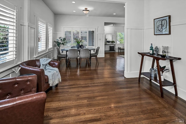interior space with a decorative wall, recessed lighting, and wood finished floors
