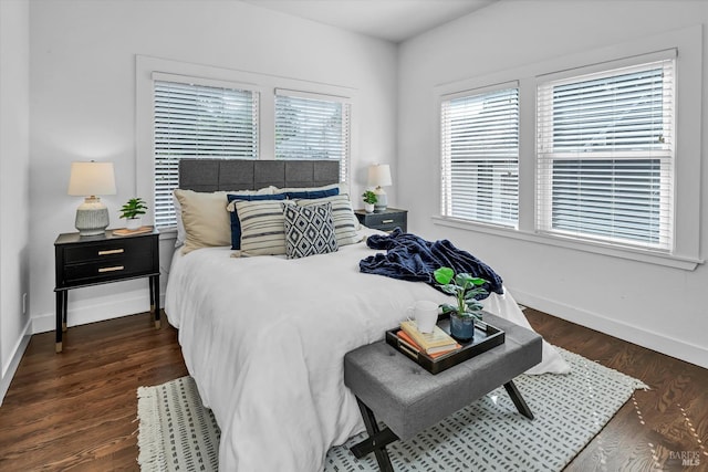 bedroom featuring dark wood-style flooring and baseboards