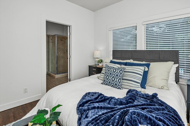 bedroom featuring ensuite bath, baseboards, and wood finished floors