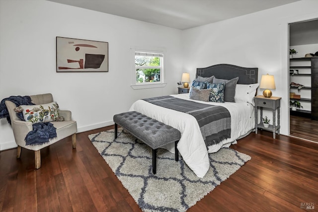 bedroom with wood finished floors and baseboards