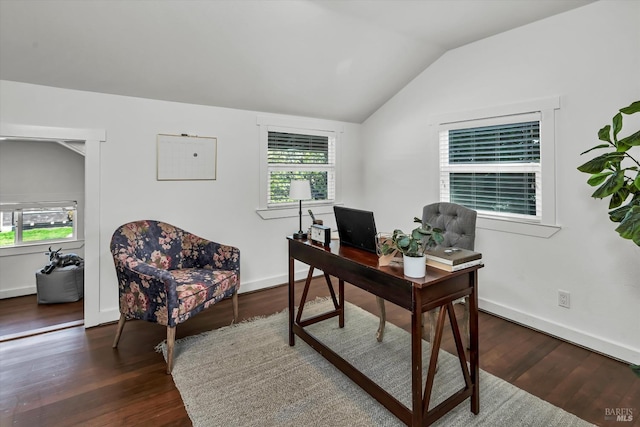 office area featuring dark wood-type flooring, vaulted ceiling, and a healthy amount of sunlight