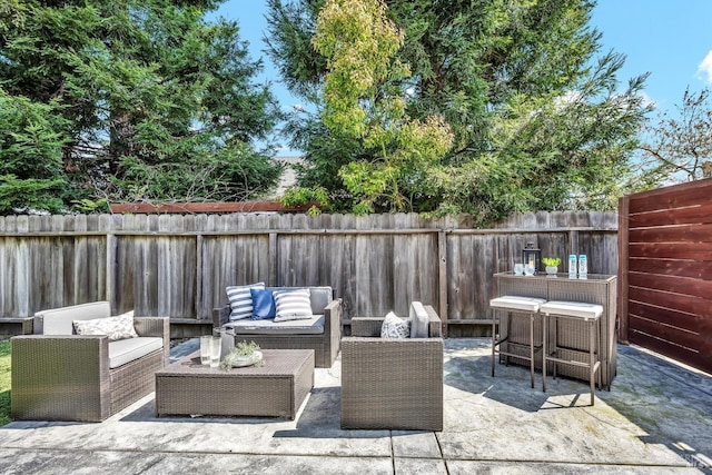 view of patio / terrace featuring a fenced backyard and an outdoor living space