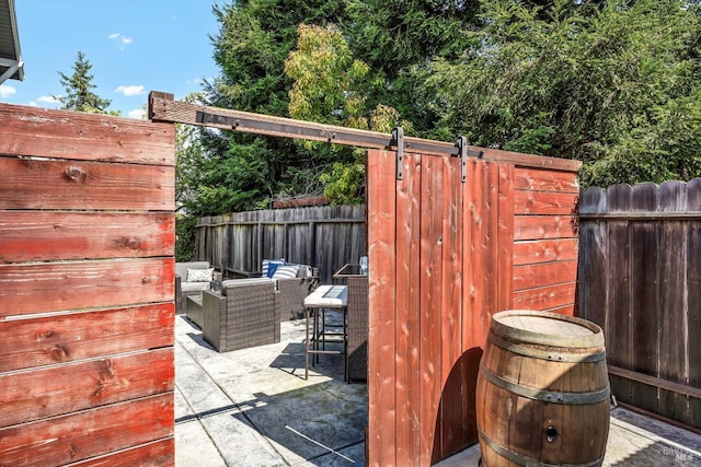 view of patio featuring outdoor lounge area and fence