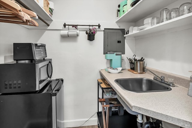 1950 Spencer St, Napa, CA 94559 - kitchen featuring electric panel, open shelves, light countertops, and fridge