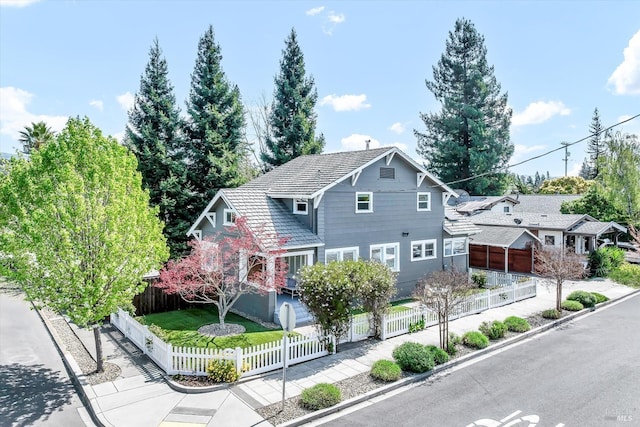 view of front of house featuring a tiled roof and a fenced front yard