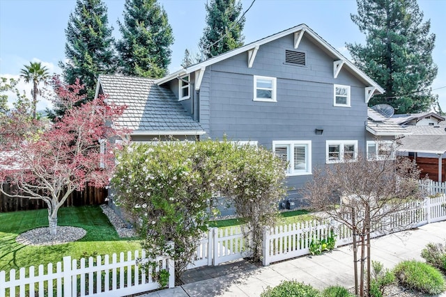 traditional home with a front yard and a fenced front yard