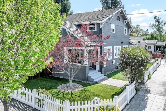 view of front facade featuring a front yard and fence private yard