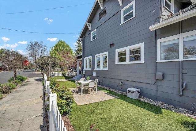 exterior space with a yard, a patio area, and fence