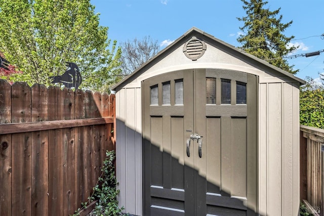 view of shed featuring fence