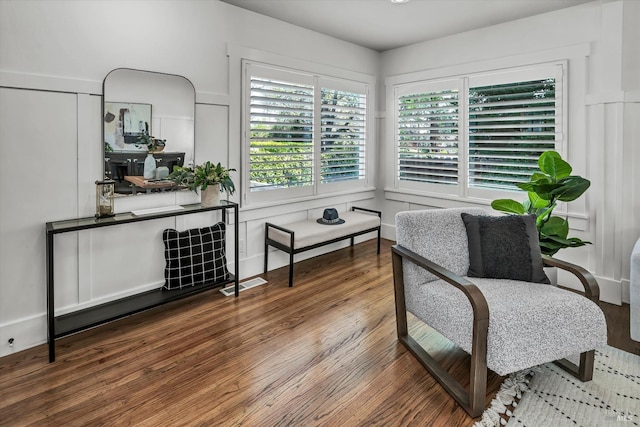 living area featuring wood finished floors and visible vents