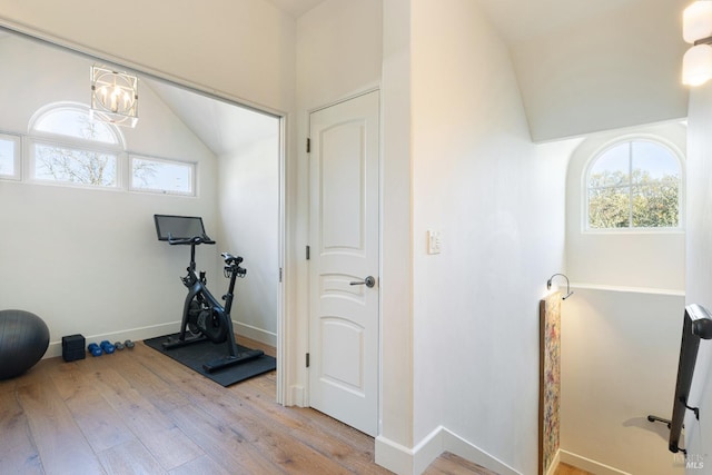 1149 Hudson Ave, Saint Helena, CA 94574 - workout area with lofted ceiling, baseboards, wood finished floors, and a chandelier