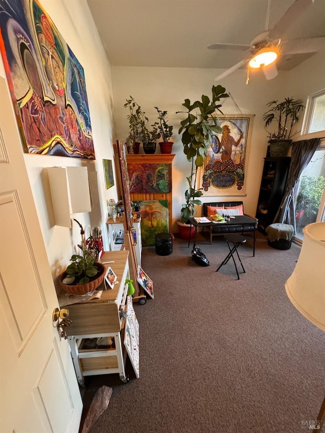 interior space featuring a ceiling fan and carpet floors