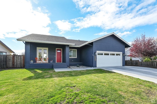 ranch-style home featuring driveway, a garage, fence, and a front yard