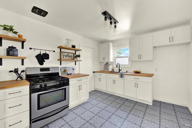 624 Annette Ave, Vallejo, CA 94591 - kitchen featuring butcher block countertops, stainless steel gas range oven, open shelves, a sink, and white cabinets
