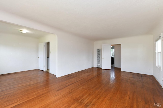 unfurnished room with wood finished floors