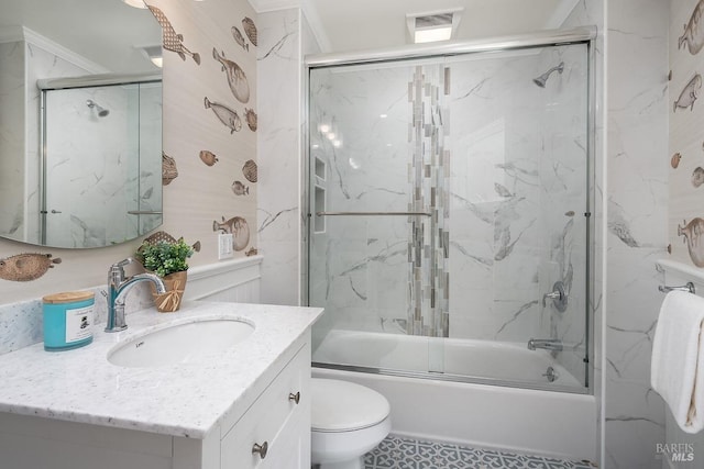bathroom with toilet, vanity, and combined bath / shower with glass door