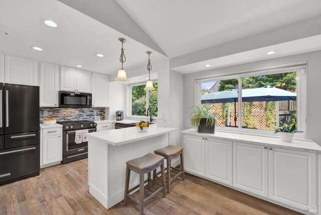 280 Park St, Concord, CA 94520 - kitchen with high end refrigerator, gas range, a peninsula, white cabinets, and lofted ceiling