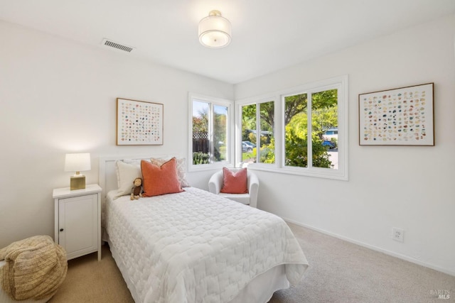 bedroom with baseboards, multiple windows, carpet flooring, and visible vents