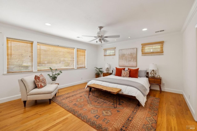 bedroom with crown molding, baseboards, and wood finished floors