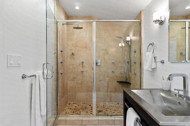 full bathroom with vanity and a stall shower