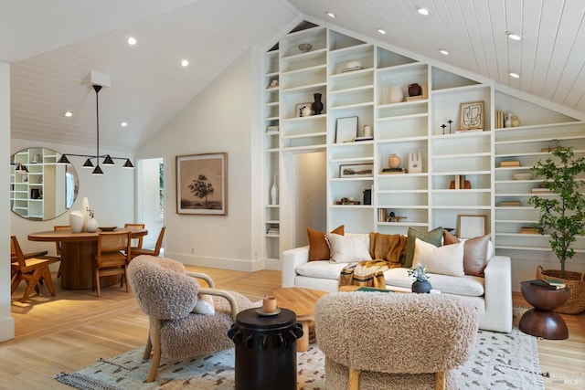 living area featuring baseboards, light wood-style flooring, built in features, and wooden ceiling