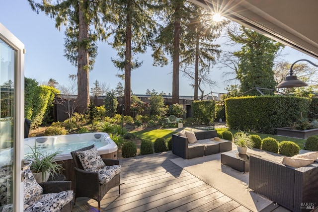 wooden deck with a fenced backyard, an outdoor hangout area, and a hot tub