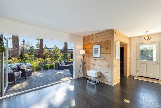 interior space featuring wood finished floors and wood walls