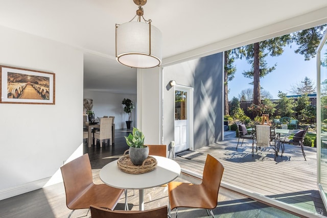 dining room featuring floor to ceiling windows and wood finished floors