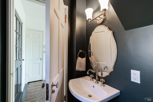bathroom featuring a sink and a textured wall