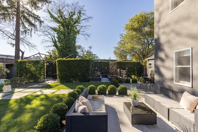 view of yard with a fenced backyard, an outdoor hangout area, and a patio area